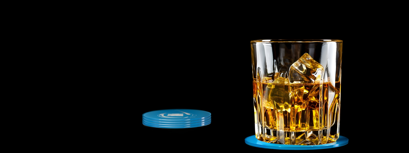 Glass of whiskey with ice cubes on a black background