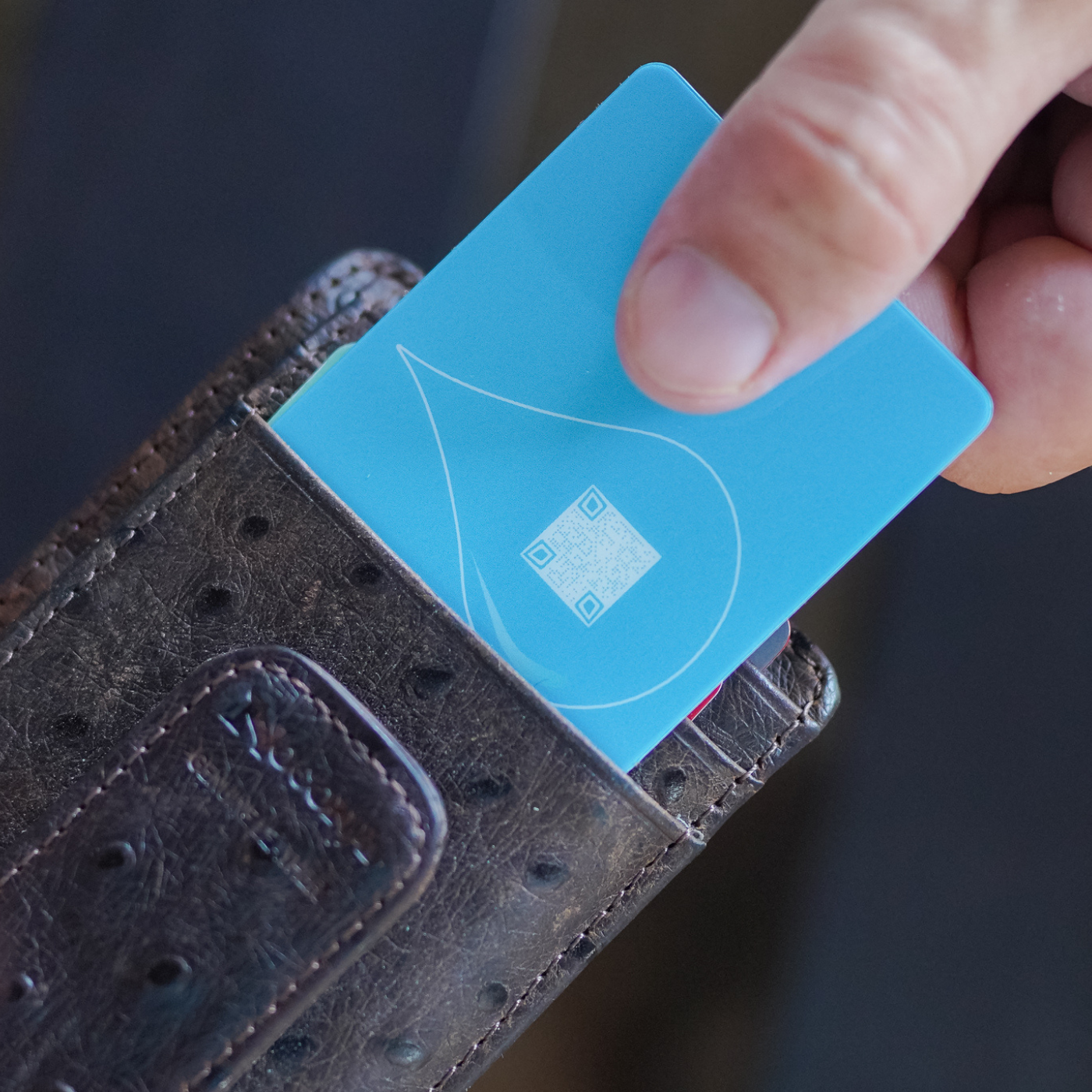 Hand holding a Boce card coasters  as its pulled out of the wallet
